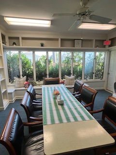 Sunlit group therapy room with garden views